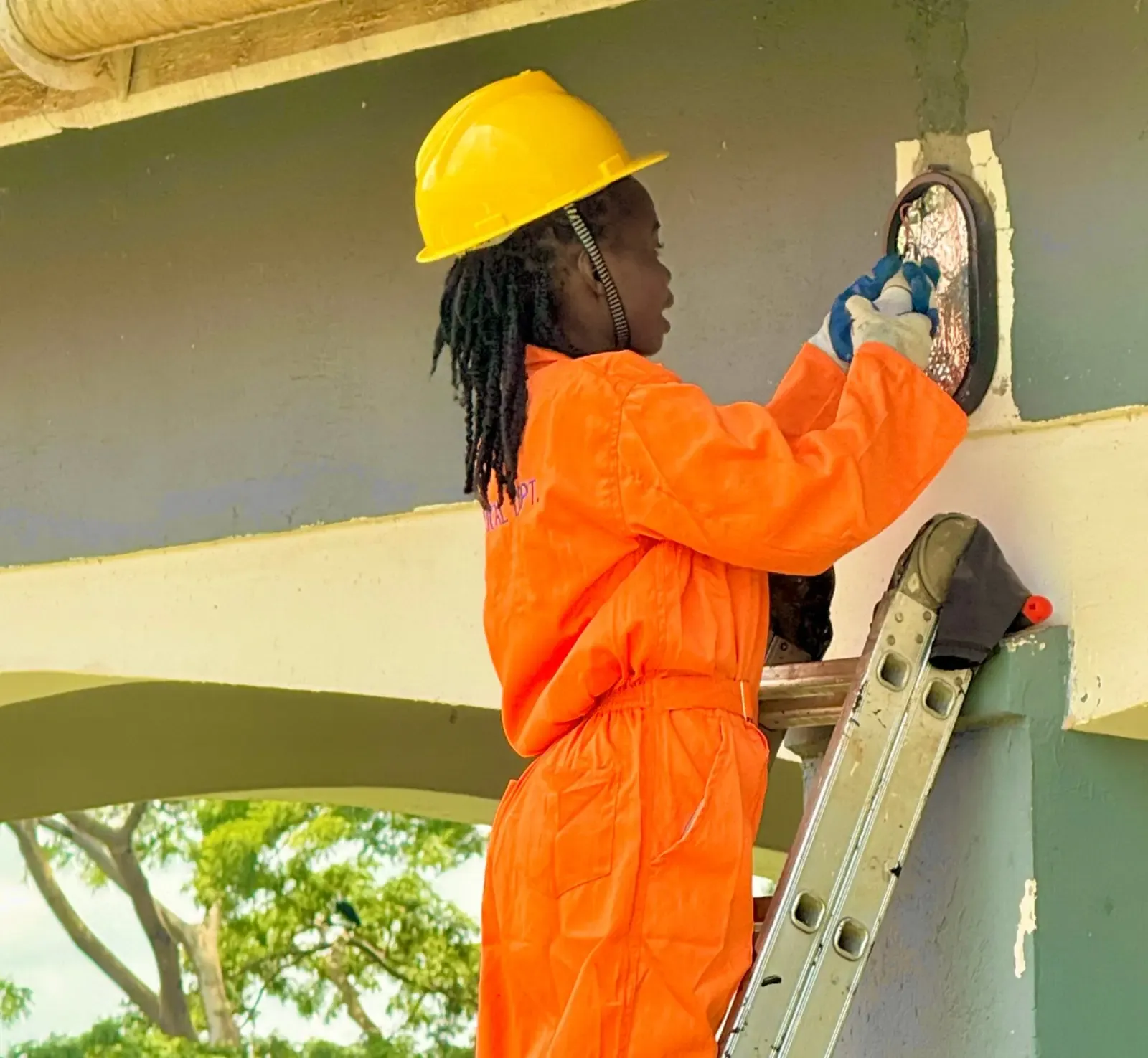 Electrical student replacing a bulb